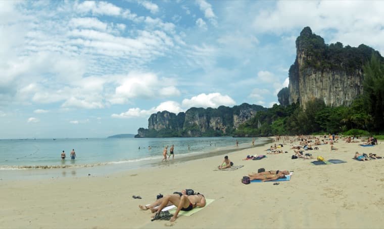 Krabi beach framed by forested limestone cliffs
