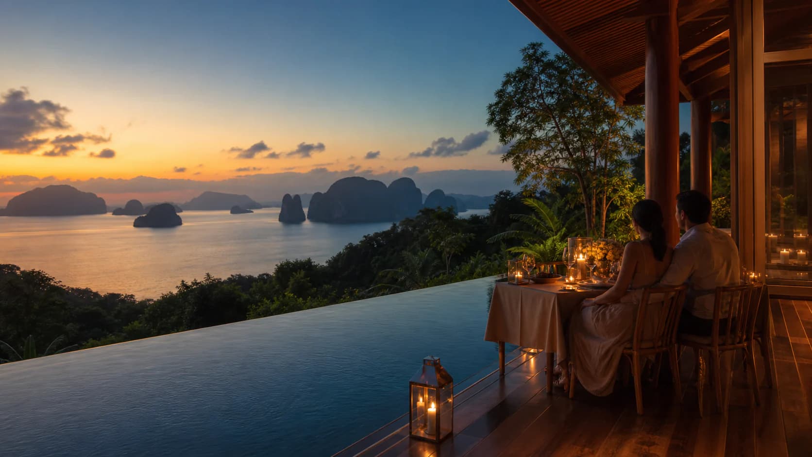 A couple sharing a private candlelit dinner overlooking Phang Nga Bay